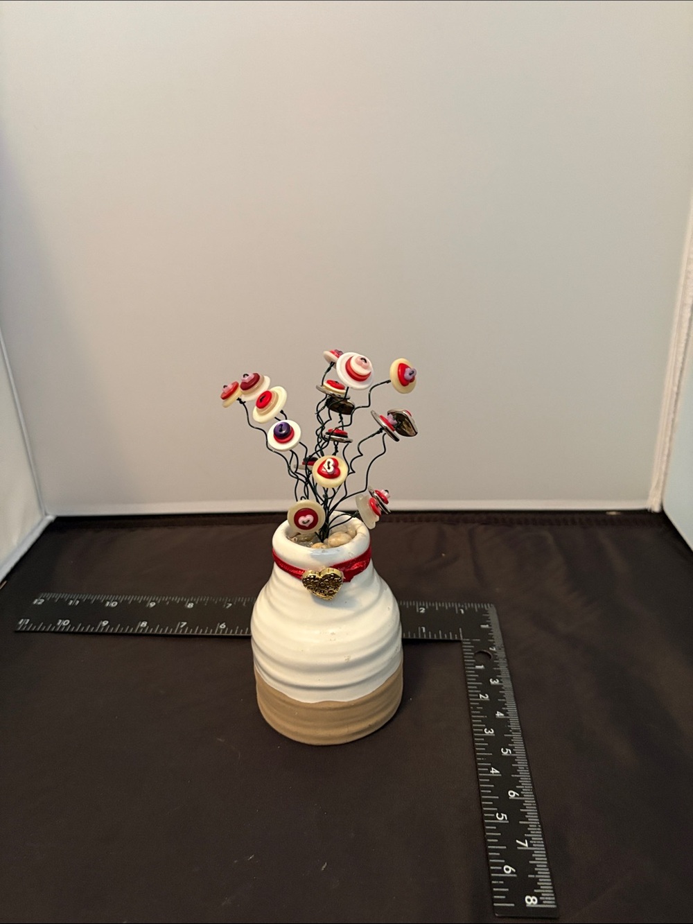 Handcrafted White and Tan Ceramic Vase with Red Button Decorative Stems
